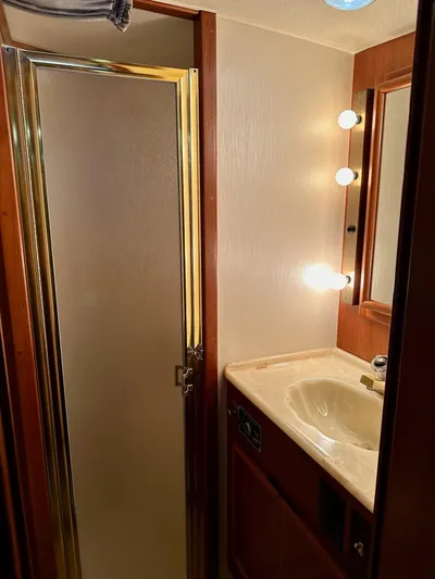 Charisma Yacht Photos Pics 1987 Post 46 SPORT yacht bathroom with shower, vanity, and mirror lighting.