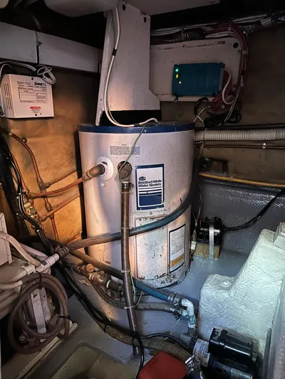 Charisma Yacht Photos Pics Engine room of a 1987 Post 46 SPORT boat with water heater and electrical components.