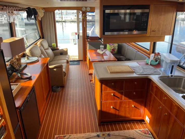  Yacht Photos Pics Luxurious interior of a 2002 Canoe Cove 50 Pilothouse Yacht with elegant wood finishes.