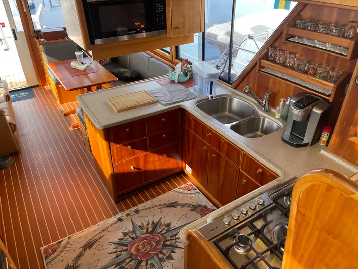 Yacht Photos Pics Luxurious 2002 Canoe Cove 50 Pilothouse Yacht kitchen with wood cabinetry and modern appliances.