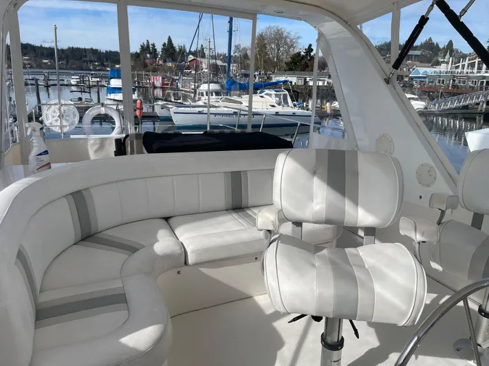  Yacht Photos Pics Luxurious 2002 Canoe Cove 50 Pilothouse Yacht interior with plush seating and marina view.