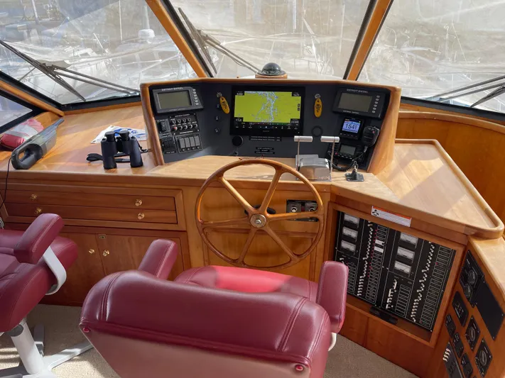  Yacht Photos Pics Pilothouse of 2002 Canoe Cove 50 Pilothouse Luxury Yacht with navigation equipment and wooden steering wheel.