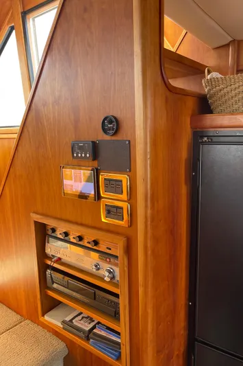  Yacht Photos Pics Interior of 2002 Canoe Cove 50 Pilothouse Yacht with wooden paneling and control instruments.