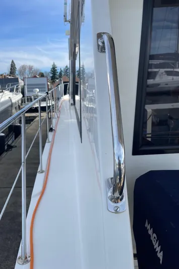  Yacht Photos Pics 2002 Canoe Cove 50 Pilothouse Yacht, side deck view with railing and window.