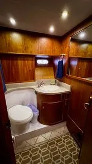  Yacht Photos Pics 2002 Canoe Cove 50 Pilothouse Yacht bathroom with wood paneling and modern fixtures.