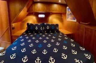  Yacht Photos Pics Luxurious bedroom in 2002 Canoe Cove 50 Pilothouse Yacht with anchor-themed bedding.