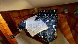  Yacht Photos Pics Luxurious bedroom in 2002 Canoe Cove 50 Pilothouse Yacht with nautical-themed bedding.