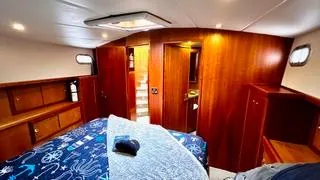  Yacht Photos Pics Luxurious bedroom interior of 2002 Canoe Cove 50 Pilothouse Yacht with wooden cabinetry.