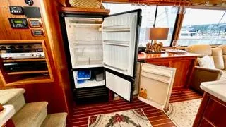  Yacht Photos Pics Luxurious interior of 2002 Canoe Cove 50 Pilothouse Yacht with open fridge.