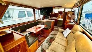  Yacht Photos Pics Luxurious interior of a 2002 Canoe Cove 50 Pilothouse Yacht with elegant seating and dining area.