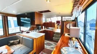  Yacht Photos Pics Luxurious interior of a 2002 Canoe Cove 50 Pilothouse Yacht with elegant wood finishes.