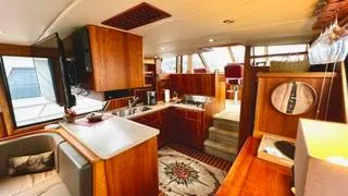  Yacht Photos Pics Luxurious interior of a 2002 Canoe Cove 50 Pilothouse Yacht with elegant wood finishes.