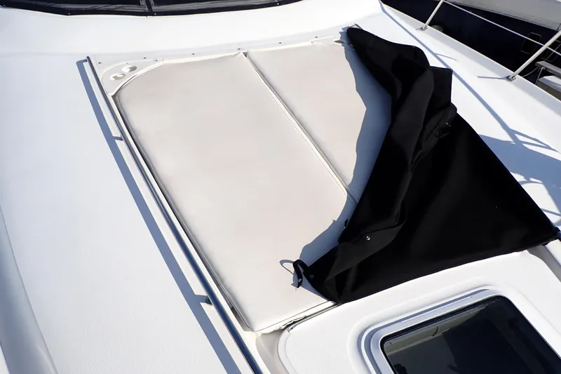 Lattitude Adjustment Yacht Photos Pics 2003 Sea Ray 480 Sedan Bridge sunpad with black cover partially open.