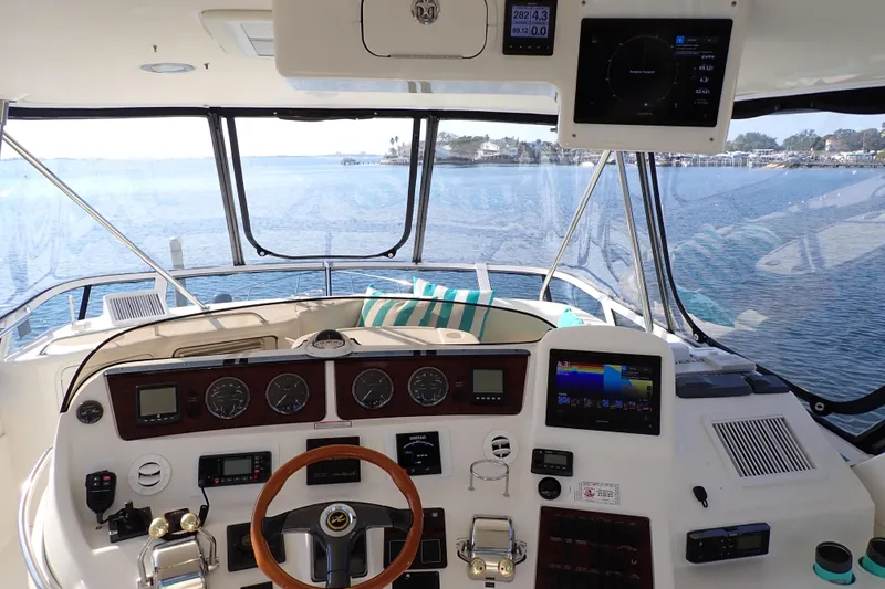 Lattitude Adjustment Yacht Photos Pics 2003 Sea Ray 480 Sedan Bridge helm with navigation instruments and ocean view.