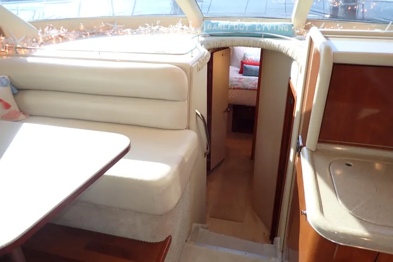 Lattitude Adjustment Yacht Photos Pics Interior of 2003 Sea Ray 480 Sedan Bridge yacht, featuring cozy seating and cabin entrance.