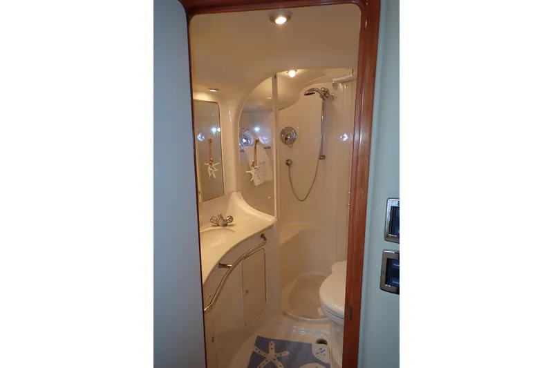 Lattitude Adjustment Yacht Photos Pics Luxurious bathroom in 2003 Sea Ray 480 Sedan Bridge yacht, featuring shower and vanity.