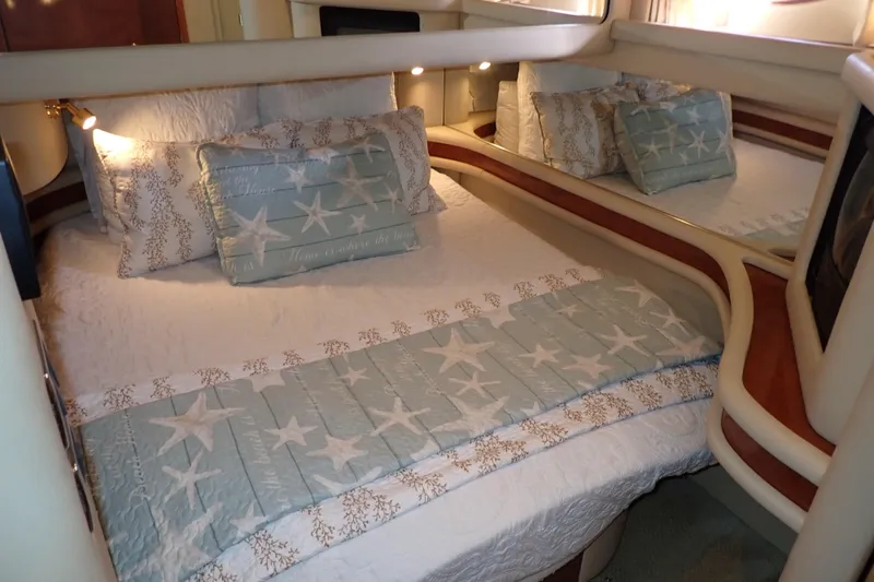 Lattitude Adjustment Yacht Photos Pics Luxurious bedroom interior of 2003 Sea Ray 480 Sedan Bridge yacht with star-themed bedding.