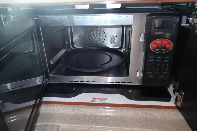 Lattitude Adjustment Yacht Photos Pics Microwave oven inside 2003 Sea Ray 480 Sedan Bridge yacht kitchen.