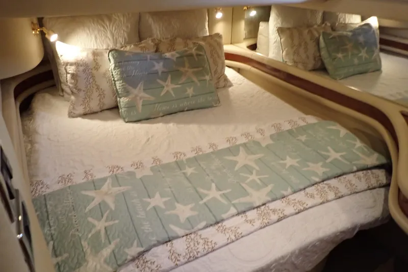 Lattitude Adjustment Yacht Photos Pics Luxurious bedroom interior of 2003 Sea Ray 480 Sedan Bridge yacht with star-themed bedding.