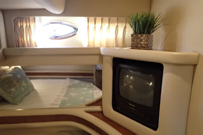 Lattitude Adjustment Yacht Photos Pics 2003 Sea Ray 480 Sedan Bridge cabin interior with TV, bed, and porthole window.