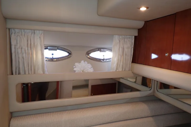 Lattitude Adjustment Yacht Photos Pics Interior of 2003 Sea Ray 480 Sedan Bridge with portholes and wooden cabinetry.