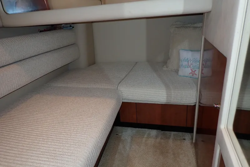 Lattitude Adjustment Yacht Photos Pics 2003 Sea Ray 480 Sedan Bridge cabin interior with cozy bedding and decorative pillows.