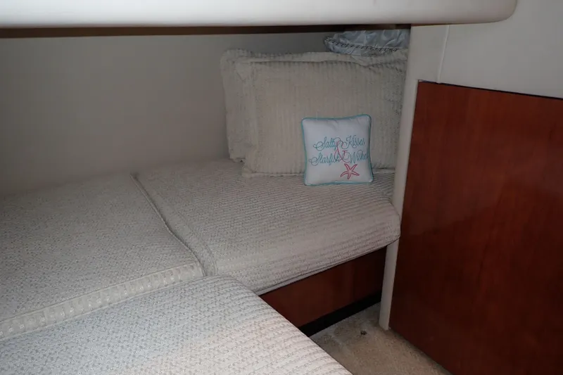 Lattitude Adjustment Yacht Photos Pics Interior cabin of 2003 Sea Ray 480 Sedan Bridge with cozy bedding and decorative pillow.