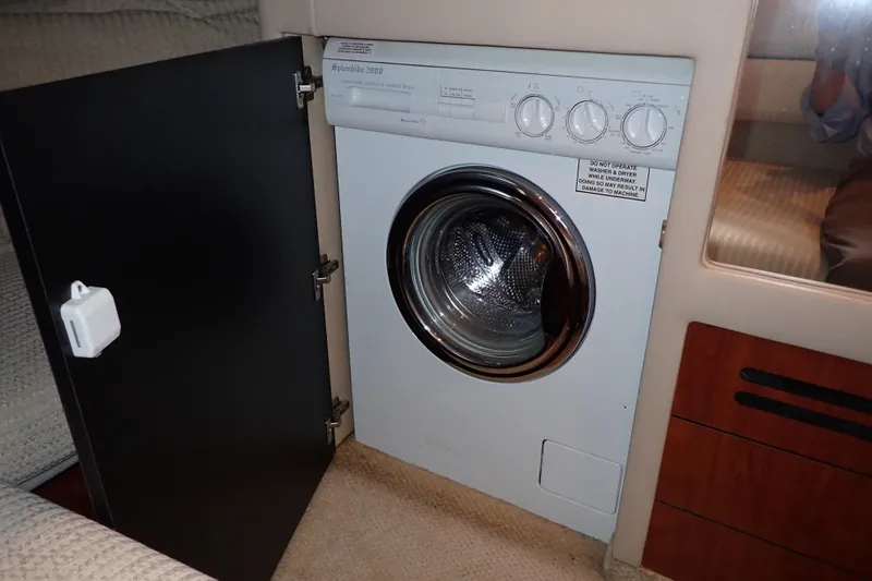 Lattitude Adjustment Yacht Photos Pics Compact washing machine inside 2003 Sea Ray 480 Sedan Bridge yacht cabin.