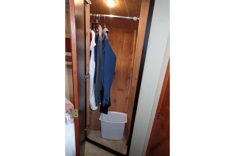 Lattitude Adjustment Yacht Photos Pics Closet interior on 2003 Sea Ray 480 Sedan Bridge with hanging clothes and storage bin.