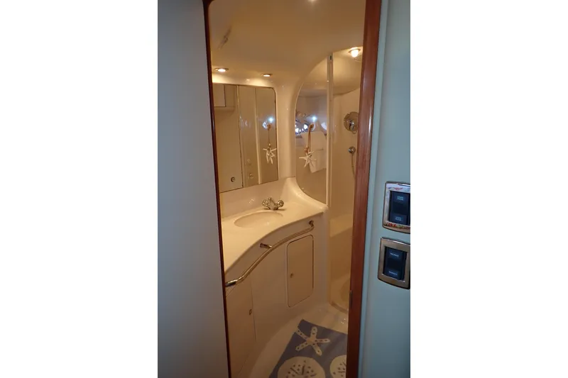 Lattitude Adjustment Yacht Photos Pics Bathroom interior of 2003 Sea Ray 480 Sedan Bridge yacht, featuring sink and shower.