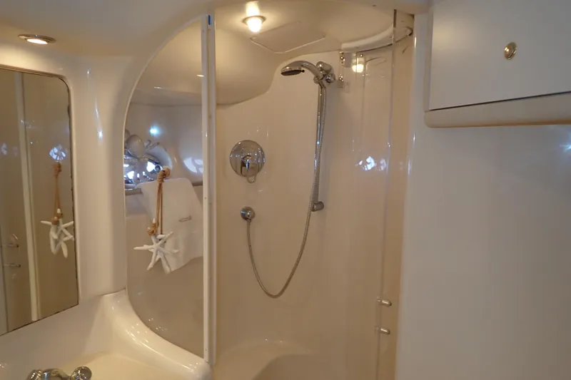 Lattitude Adjustment Yacht Photos Pics Luxurious bathroom in 2003 Sea Ray 480 Sedan Bridge yacht, featuring elegant shower design.