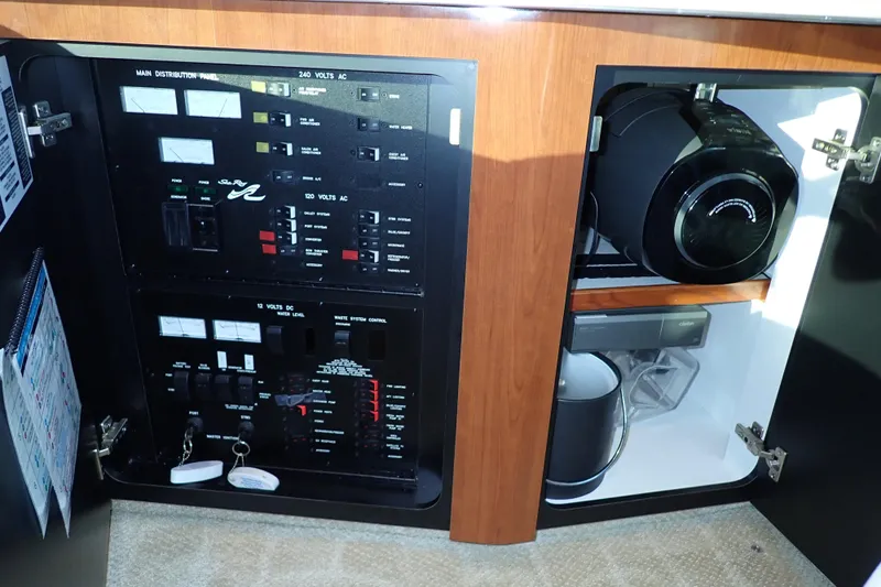 Lattitude Adjustment Yacht Photos Pics Electrical panel and storage in 2003 Sea Ray 480 Sedan Bridge yacht interior.