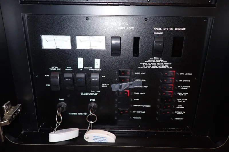 Lattitude Adjustment Yacht Photos Pics Control panel of a 2003 Sea Ray 480 Sedan Bridge yacht, featuring various switches and gauges.