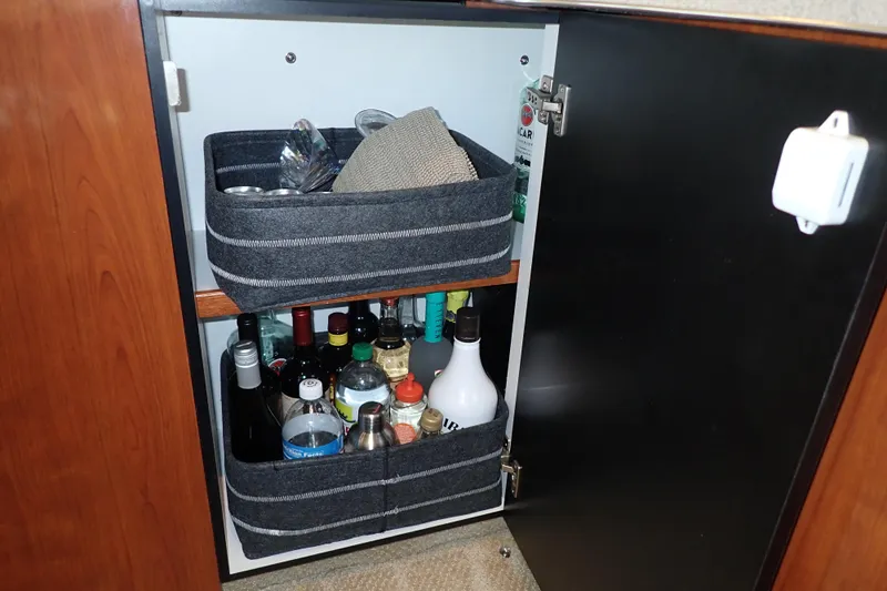 Lattitude Adjustment Yacht Photos Pics Cabinet storage with beverages and accessories on a 2003 Sea Ray 480 Sedan Bridge.