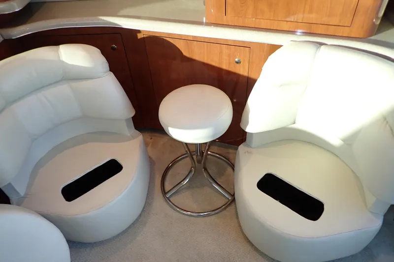 Lattitude Adjustment Yacht Photos Pics Interior seating of 2003 Sea Ray 480 Sedan Bridge yacht with white leather chairs.