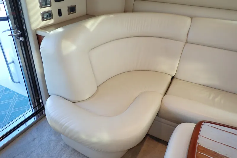 Lattitude Adjustment Yacht Photos Pics Luxurious white leather seating in 2003 Sea Ray 480 Sedan Bridge yacht interior.