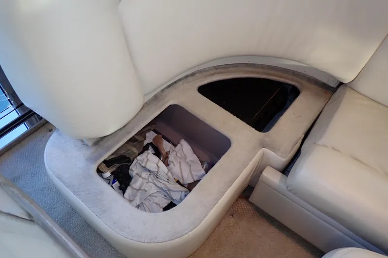 Lattitude Adjustment Yacht Photos Pics Storage compartment under seat in 2003 Sea Ray 480 Sedan Bridge yacht interior.