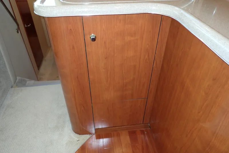 Lattitude Adjustment Yacht Photos Pics 2003 Sea Ray 480 Sedan Bridge interior with wood cabinetry and countertop.