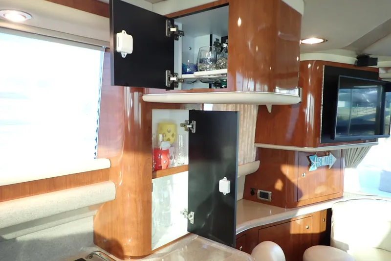 Lattitude Adjustment Yacht Photos Pics 2003 Sea Ray 480 Sedan Bridge interior with open cabinets and modern decor.