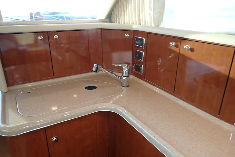 Lattitude Adjustment Yacht Photos Pics Luxurious kitchen area in 2003 Sea Ray 480 Sedan Bridge yacht.