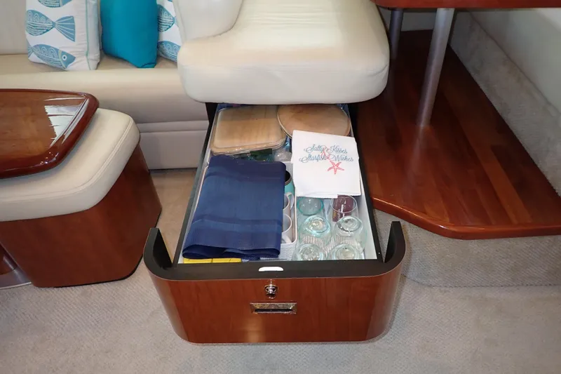Lattitude Adjustment Yacht Photos Pics Open drawer in 2003 Sea Ray 480 Sedan Bridge, displaying glassware and napkins.