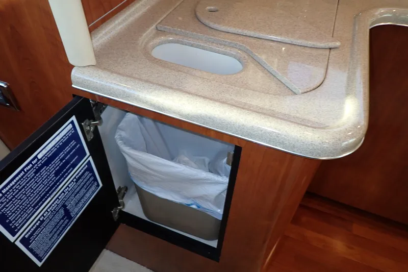 Lattitude Adjustment Yacht Photos Pics Kitchen area of 2003 Sea Ray 480 Sedan Bridge with trash compartment open.