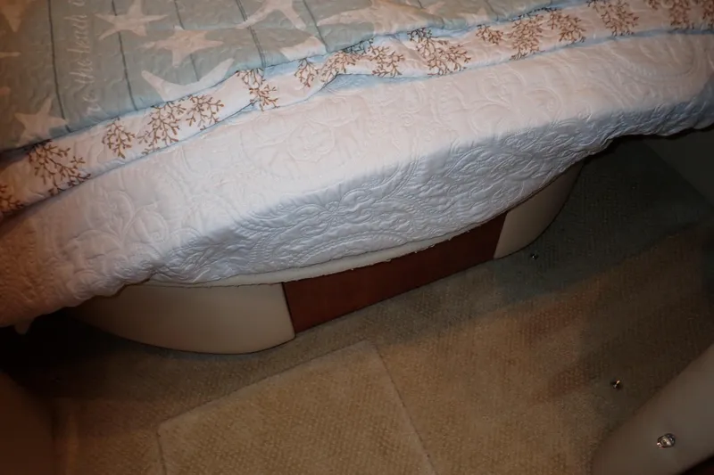 Lattitude Adjustment Yacht Photos Pics Interior cabin of 2003 Sea Ray 480 Sedan Bridge with quilted bedding.