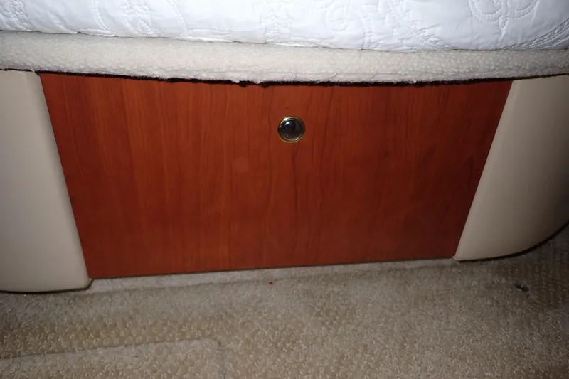 Lattitude Adjustment Yacht Photos Pics Wooden panel with a circular handle on a 2003 Sea Ray 480 Sedan Bridge.