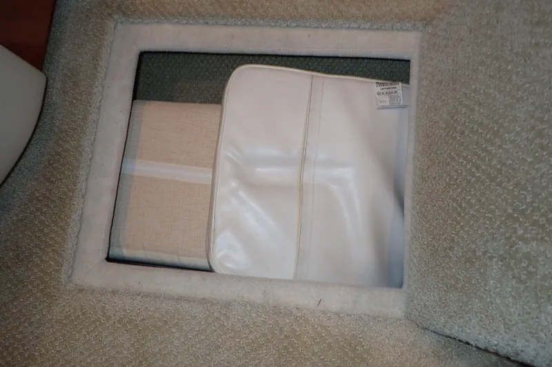 Lattitude Adjustment Yacht Photos Pics Storage compartment on 2003 Sea Ray 480 Sedan Bridge with white cover and beige fabric.