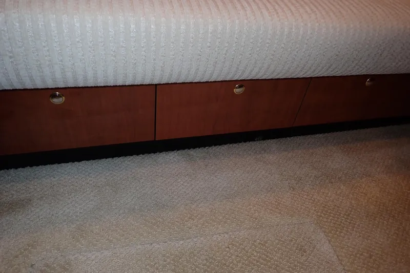 Lattitude Adjustment Yacht Photos Pics Interior view of 2003 Sea Ray 480 Sedan Bridge with carpet and wooden storage.