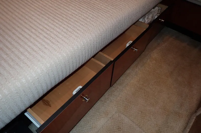 Lattitude Adjustment Yacht Photos Pics Under-bed storage drawers in a 2003 Sea Ray 480 Sedan Bridge yacht interior.