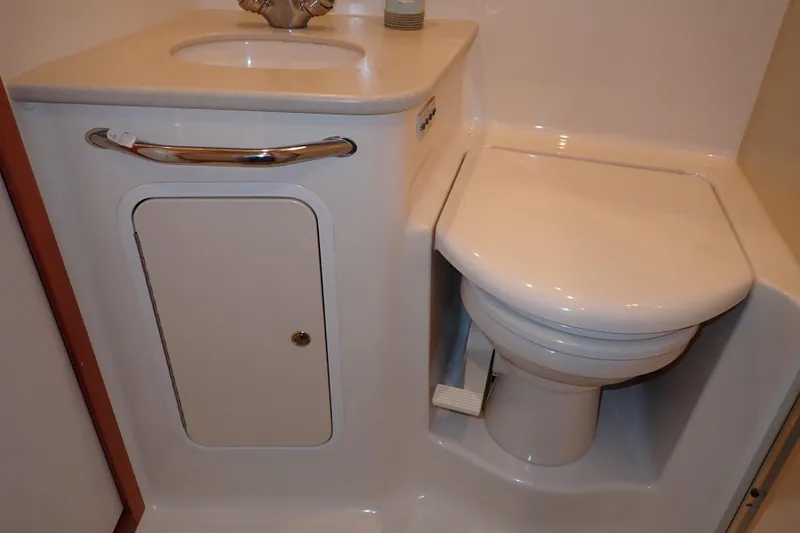 Lattitude Adjustment Yacht Photos Pics 2003 Sea Ray 480 Sedan Bridge bathroom with toilet and sink.