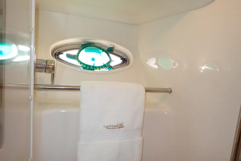 Lattitude Adjustment Yacht Photos Pics Bathroom interior of 2003 Sea Ray 480 Sedan Bridge yacht with towel and porthole.