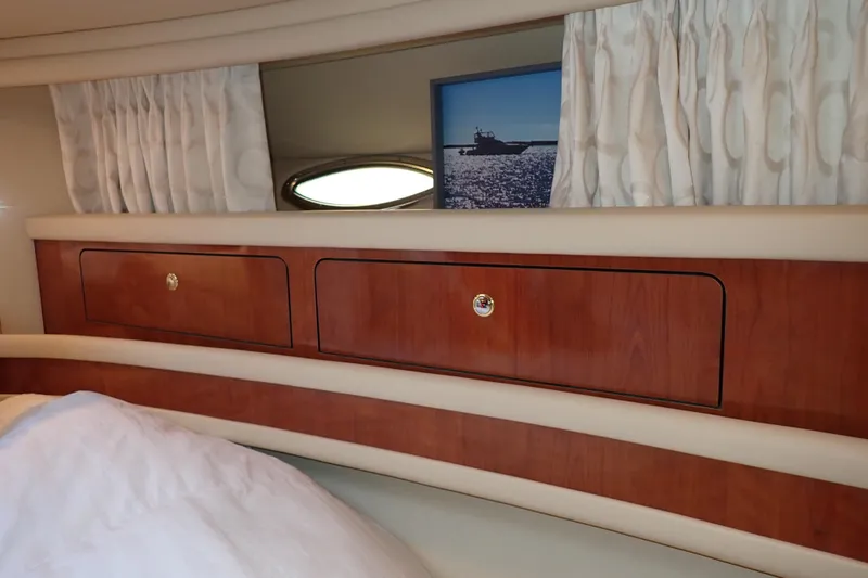 Lattitude Adjustment Yacht Photos Pics Interior of 2003 Sea Ray 480 Sedan Bridge with wooden cabinets and curtains.